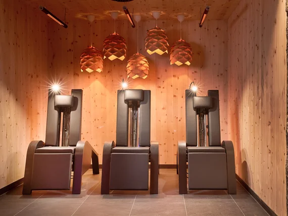 Modern wooden interior with five stylish stools and pinecone-shaped lamps