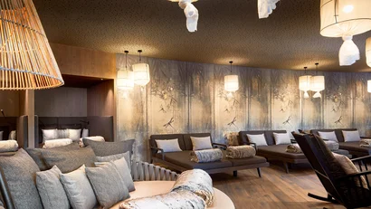 Cozy lounge area with soft sofas and decorative hanging lamps