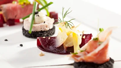 Elegantly plated appetizers with salmon and vegetable garnishes