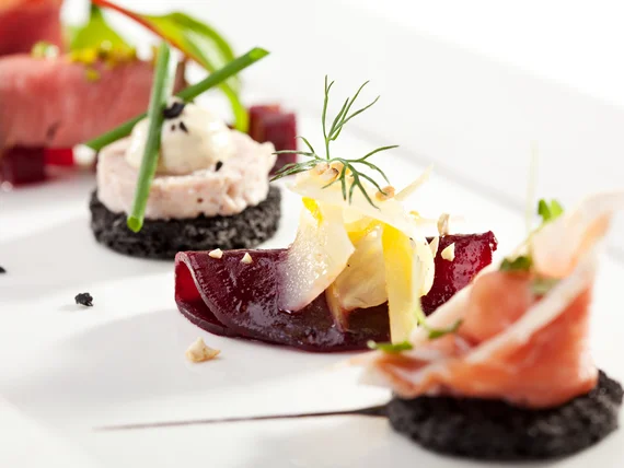 Elegantly plated appetizers with salmon and vegetable garnishes