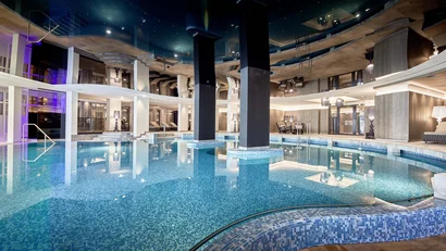 Modern indoor pool with columns and blue-white mosaic tiles