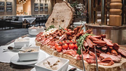 Buffet with assorted sausages and cheeses in elegant restaurant
