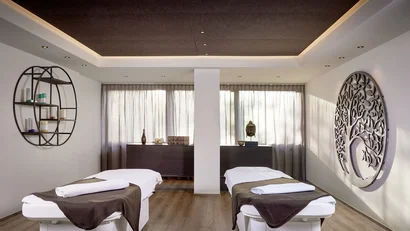 Cozy massage room with two massage tables and wall decoration