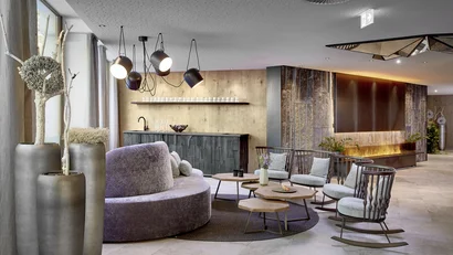 Modern lounge with wood and stone elements and comfortable seating area
