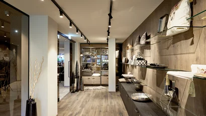 Modern hallway with wooden floor and glass shelves on the wall