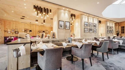 Modern restaurant interior with wooden walls and set dining tables